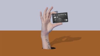 a hand holding a credit card