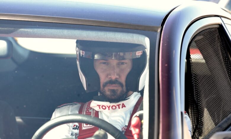 Keanu Reeves speeds around the Indy 500 racetrack