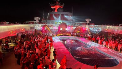 Passengers crowd around the pool for a rave-style Scarlet Night party on Virgin Voyages' Resilient Lady.