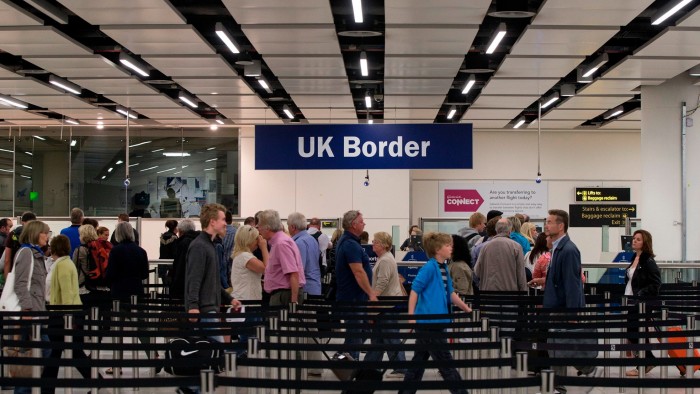 Border Force check the passports of passengers arriving at Gatwick Airport