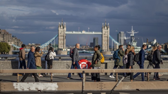 City office workers cross London Bridge