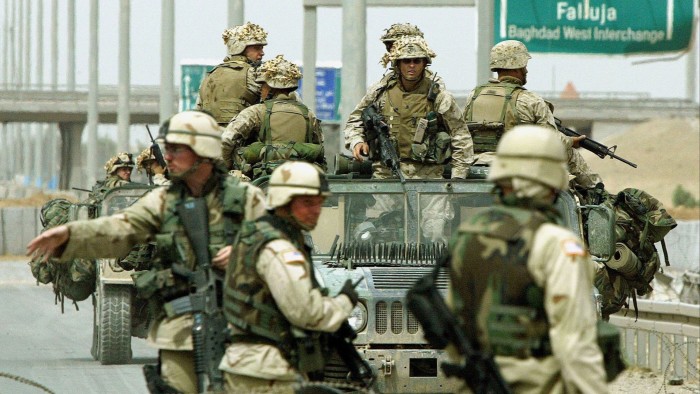 US soldiers stand guard at the first check point at the entrance in Fallujah, Iraq, 29 April 2004