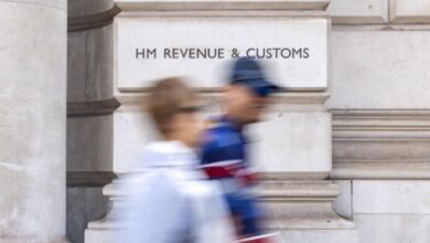 People walk past a HM Revenue & Customs office in London