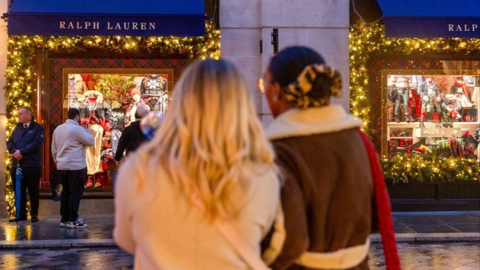 Shoppers take photos of the Christmas decorations at a Ralph Lauren store in London