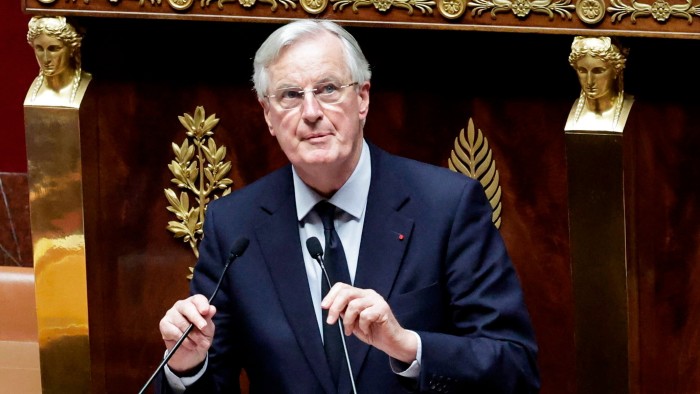 Michel Barnier delivers a speech at the podium during the voting session on the social security bill 2025 at the National Assembly