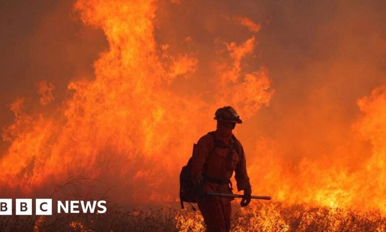 Firefighters battle a massive blaze near Los Angeles as winds pick up